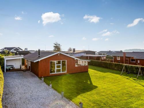 a home with a green yard with a house at Holiday Home Ali - 500m from the sea by Interhome in Hejlsminde