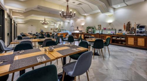 a dining room with wooden tables and chairs at AZZ Guadacorte Campo de Gibraltar in Los Barrios