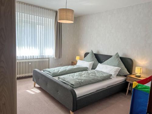 a bedroom with a bed and a large window at Apartment Celine by Interhome in Lügde