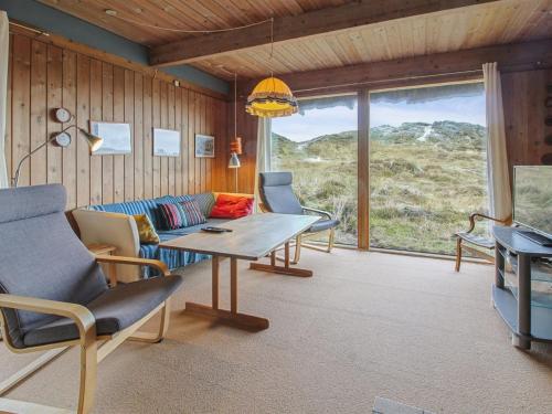 a living room with a couch and a table at Holiday Home Asel - 1km from the sea by Interhome in Sønderho