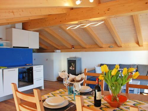 a kitchen with a table with yellow flowers on it at Apartment Cà dal Non by Interhome in Ronco s/Ascona - Porto Ronco