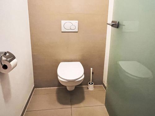 a bathroom with a white toilet in a stall at Apartment Cheeky Apartment-5 by Interhome in Oberndorf in Tirol
