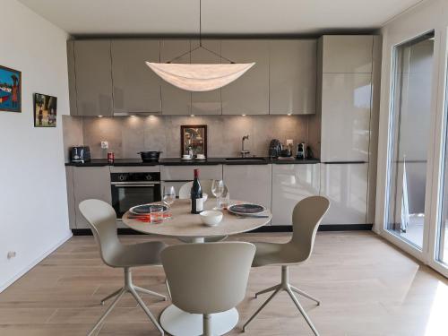 a kitchen with a table and chairs in a room at Studio Les Oréades C by Interhome in La Tour-de-Peilz
