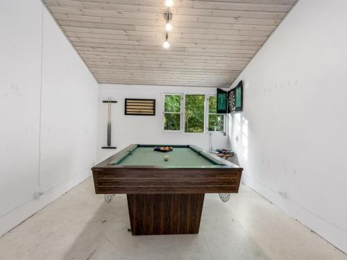 a pool table in a room with a ceiling at Holiday Home Ranka - 300m from the sea by Interhome in Strøby Ladeplads