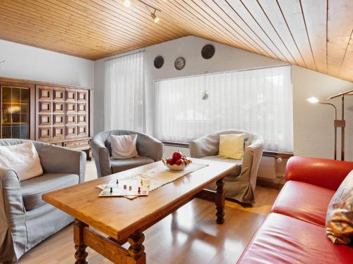 a living room with couches and a wooden table at Apartment Castor und Pollux-6 by Interhome in Täsch