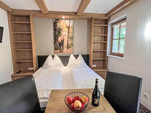 a bedroom with a bed with a bowl of fruit on a table at Apartment Cheeky Apartment-3 by Interhome in Oberndorf in Tirol