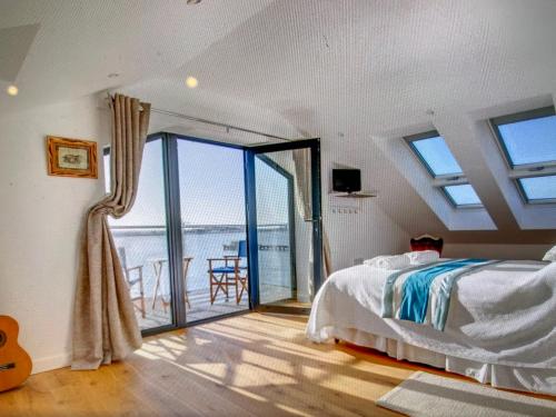a bedroom with a bed and a balcony at Ten Admiralty Pier in Shotley Gate