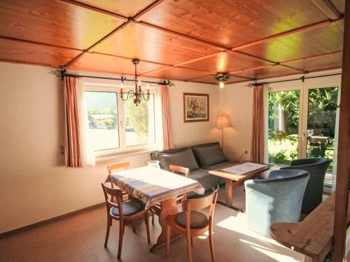 a living room with a table and a couch at Studio Studio Biara mit Wintergarten by Interhome in Gortipohl