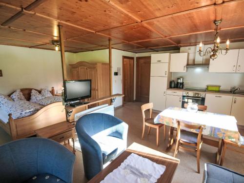 a living room with a bed and a table and chairs at Studio Studio Biara mit Wintergarten by Interhome in Gortipohl