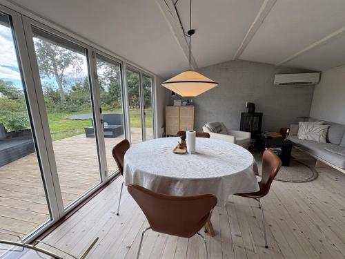 a dining room with a table and chairs and a living room at Holiday Home Gun - 300m to the fjord by Interhome in Glostrup