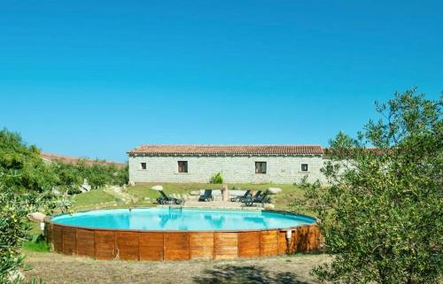 a pool in the yard of a house at ISA - Lofts with private outdoor area and swimming-pool in Badesi in Badesi