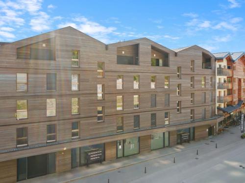 a large wooden building with windows on a street at Apartment Central Parc 2 by Interhome in Crans-Montana