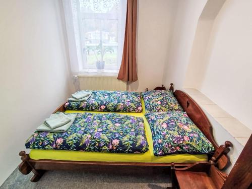 a bedroom with two beds with colorful blankets at Apartment Riedlovka 2 by Interhome in Polubný