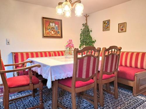 a dining room with a table and chairs and a couch at Holiday Home Lindnerhof by Interhome in Helpfau-Uttendorf