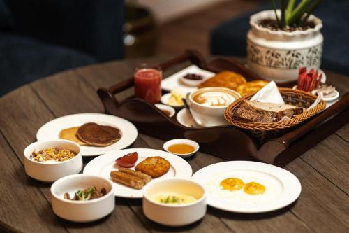a tray of food on a table with plates of food at The Hush Nepal in Kathmandu