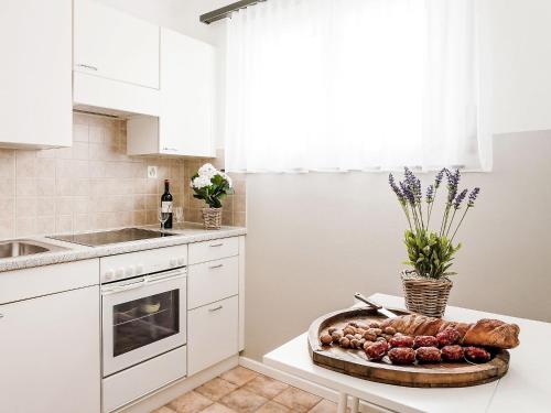 a white kitchen with a tray of food on a counter at Apartment Junior Suite-7 by Interhome in Ascona