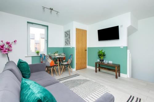 a living room with a couch and a table at Carnforth 91 by Alt-Stay Contractor Accommodation - 2 Bed En-suite Contractor Home With Parking, Wi-Fi & Full Kitchen - Ideal For Long stays in Wakefield