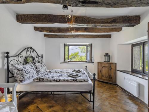 a bedroom with a bed in a room with wooden ceilings at Holiday Home Rosa by Interhome in Agarone