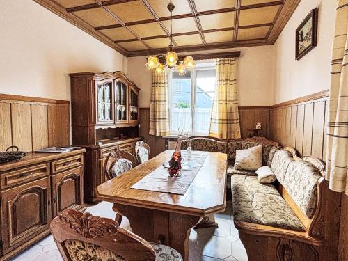 a living room with a table and a couch at Holiday Home Großmutters Ferienhaus by Interhome in Mörbisch am See