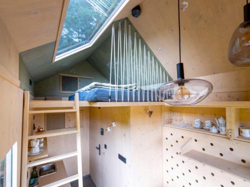 a tree house with a bed and a window at Chalet Glamping Sokolka by Interhome in Branžež