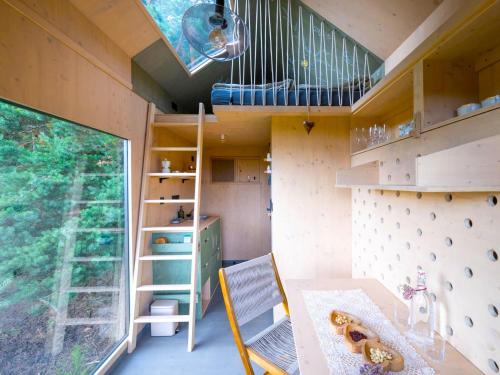 a tiny house with a staircase and a desk at Chalet Glamping Sokolka by Interhome in Branžež