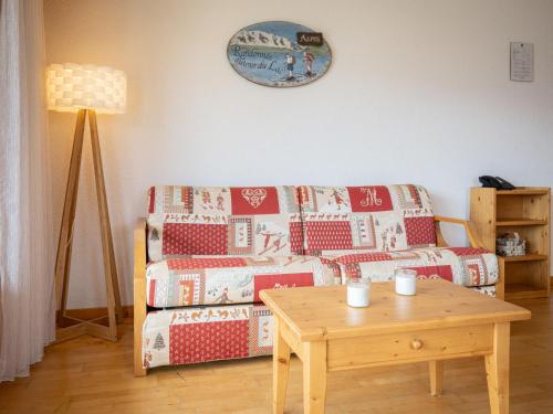 a living room with a couch and a table at Apartment Sources 4110 by Interhome in Ovronnaz
