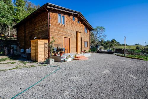 a house with a gravel driveway in front of it at Casa Mario in La Giustiniana