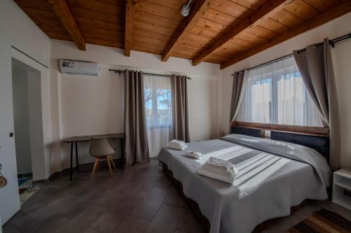 a bedroom with a bed and a desk in it at Casale in legno nella natura laziale in La Giustiniana