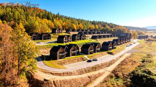 an aerial view of a row of houses on a road at Wonder Hill - bajkowy widok na góry i zalew in Sosnówka