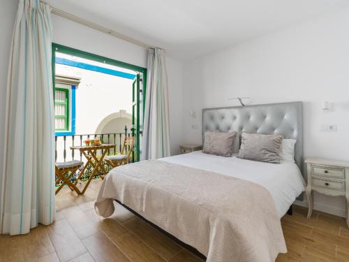 a bedroom with a large bed and a balcony at Marina nº 296 in Puerto de Mogán