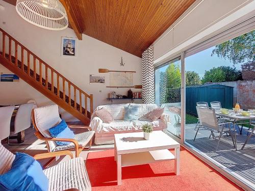 a living room with a couch and a table at Holiday Home Les Floriales by Interhome in Vaux-sur-Mer