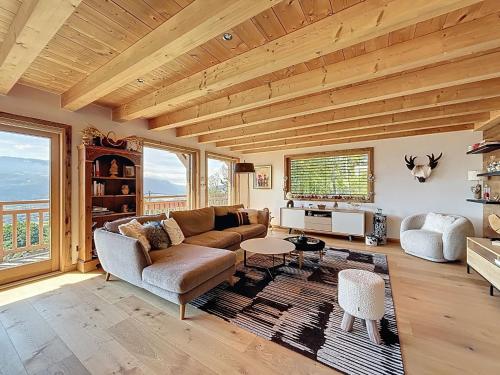 a living room with a couch and a table at Chalet Chalet ECO by Interhome in Thyez