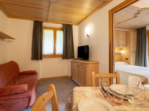 a living room with a bed and a dining table at Apartment Residence gli Scoiattoli-1 by Interhome in Madesimo