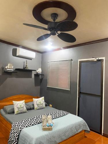 a bedroom with two beds and a ceiling fan at Spacious Modern 4BR Home with 24hr Security and Parking in Cagayan de Oro