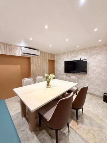 a conference room with a large table and chairs at Hotel Roop Cliff, Bhopal in Bhopal