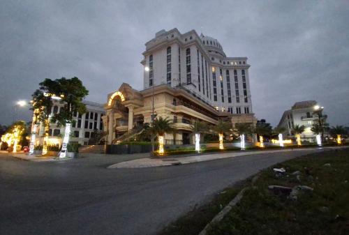 a large building at night with a street in front at The Dome Grand in Ninh Lão