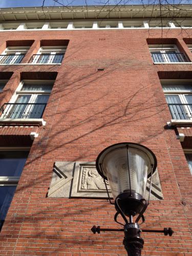 a street light in front of a brick building at Dutch Design Hotel Vondelpark in Amsterdam