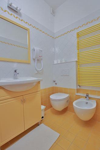 a bathroom with a sink and a toilet and a mirror at Jolly Roger Riomaggiore in Riomaggiore