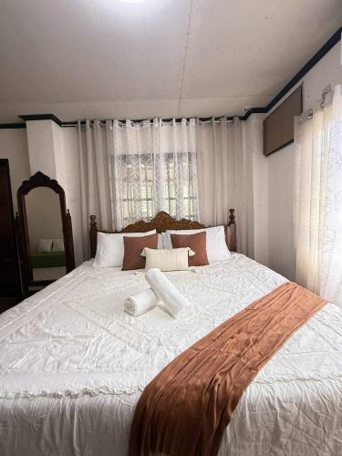 a large white bed with two white towels on it at Verandas Beach Resort in Carmen