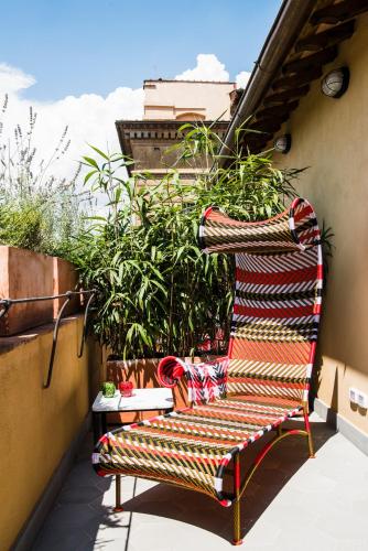 a bench sitting on a balcony with plants at Hotel Milu Florence in Florence