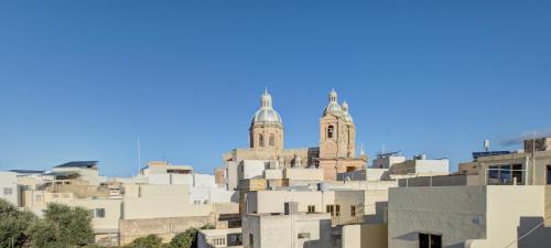 a building with two towers on top of it at Traditional Maltese Escape with Rooftop Terrace by 360 Estates in Dingli