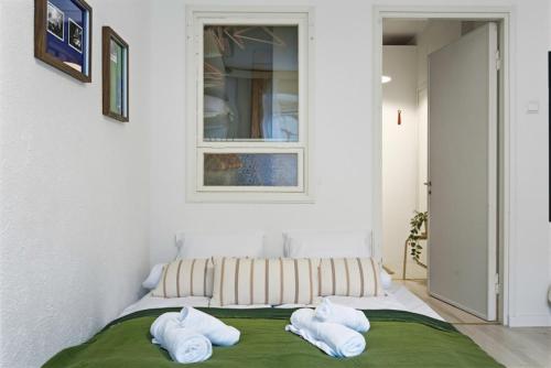 a bedroom with a bed with towels on it at Scandi Luxury Renovated Central Access in Helsinki