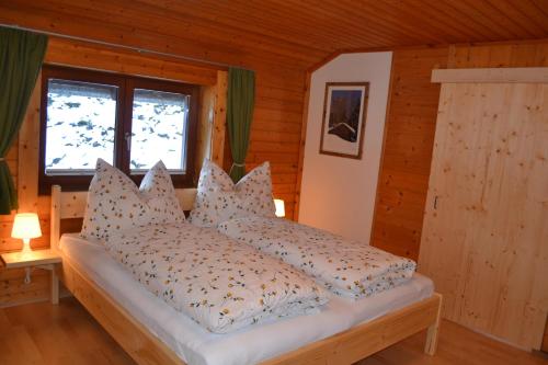 a bedroom with a bed with pillows on it at FamilienAppartement Waldstüberl in Kleinarl