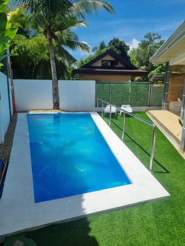 a swimming pool in the backyard of a house at UB HOME in Dauis