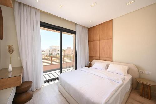 a bedroom with a bed and a large window at Stunning 3 bd penthouse with private pool - El Gouna in El Gouna