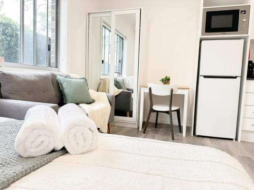a living room with a couch and a table at North Wollongong - Beach Style - Modern - Free Parking - Free Coffee Snacks in Woonona