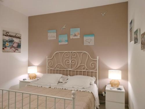 a bedroom with a bed with two night stands and two lamps at La casa di Ieia in Porto Ercole