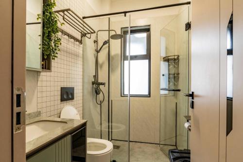 een badkamer met een douche, een toilet en een wastafel bij Oak Classic Residence in Nairobi