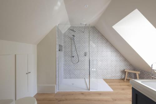 a bathroom with a shower in the attic at Riverview in Brockenhurst