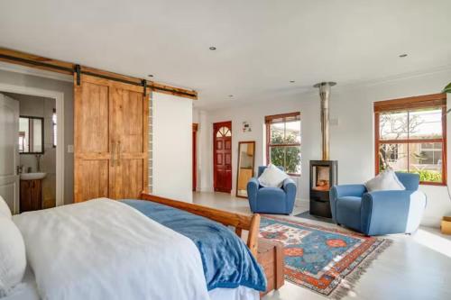 a bedroom with a bed and two blue chairs at #5A on Brassie in Lakeside